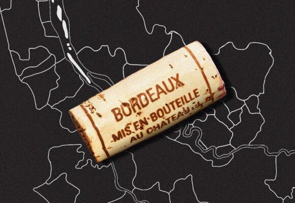A bordeaux cork resting on a map of the left and right banks of bordeaux