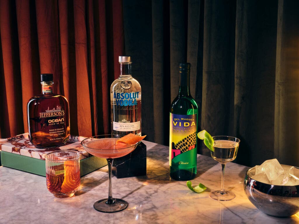 Bottles of liquor next to cocktails