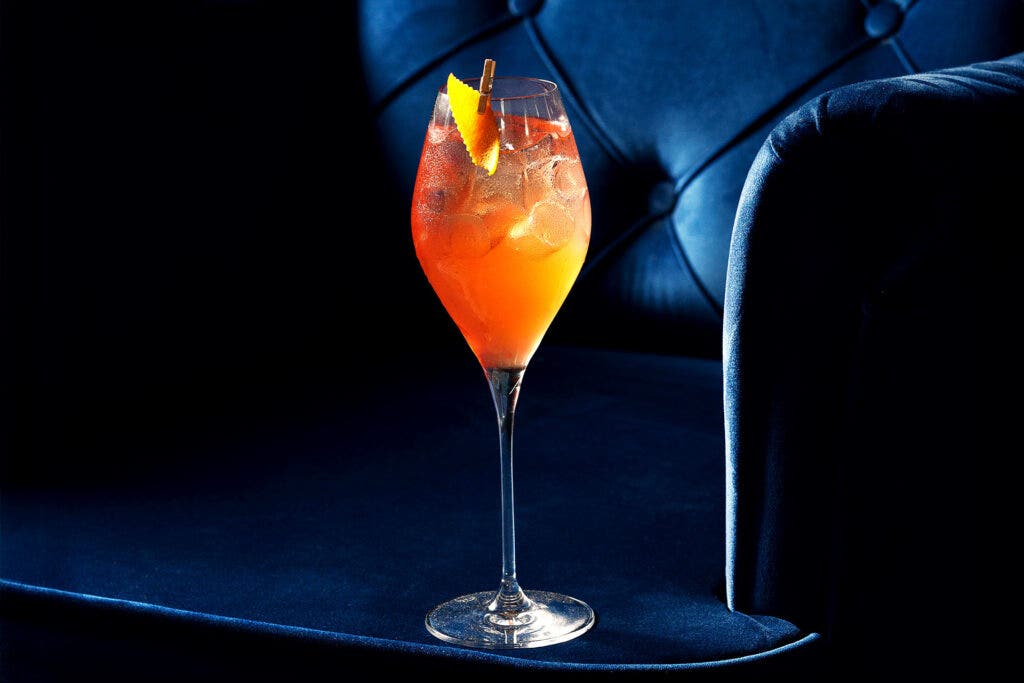 Spritz cocktail on a blue chair